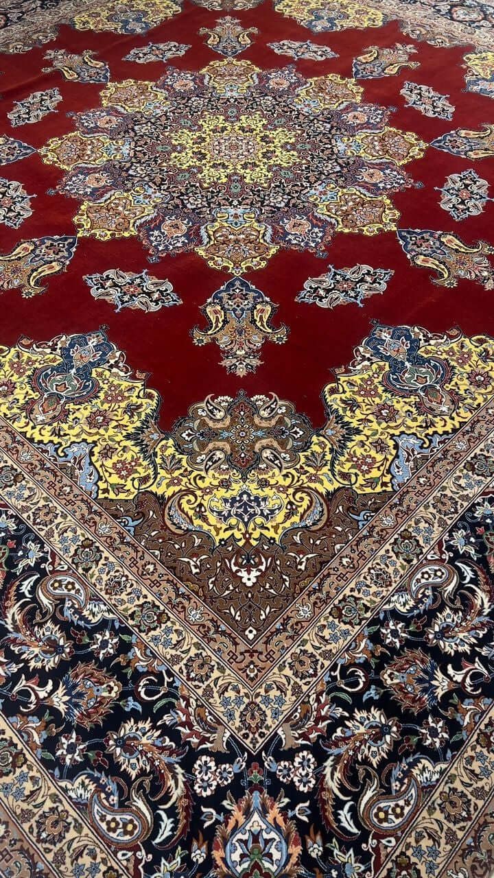 "Close-up of the vibrant yellow medallion design on a silk and wool Persian rug."